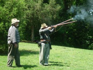 Civil War reenactors shooting guns.