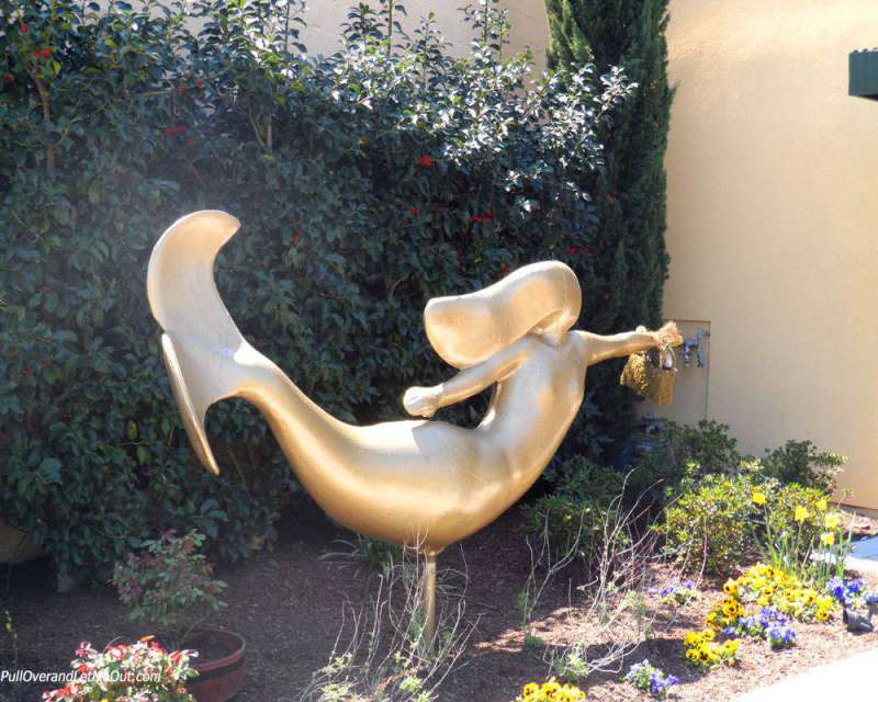 a gold mermaid statue