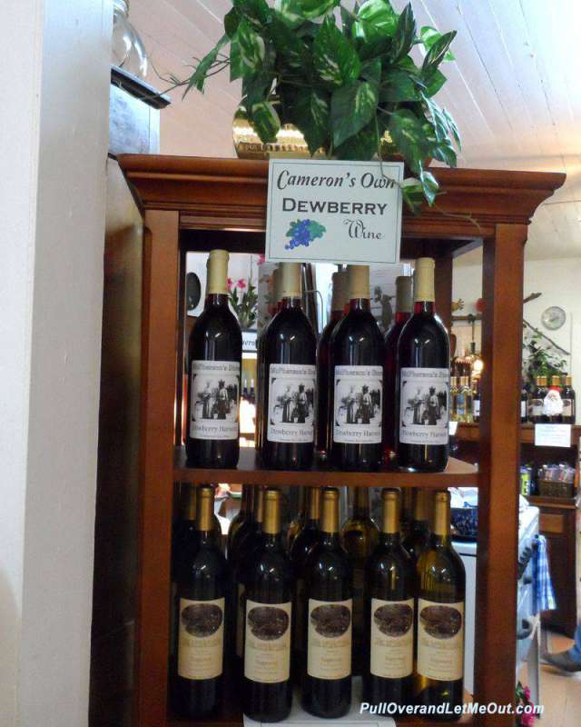 bottles of dewberry wine in a cabinet in a shop