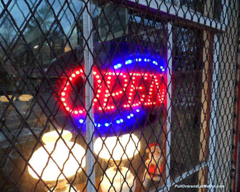 a neon open sign in a window