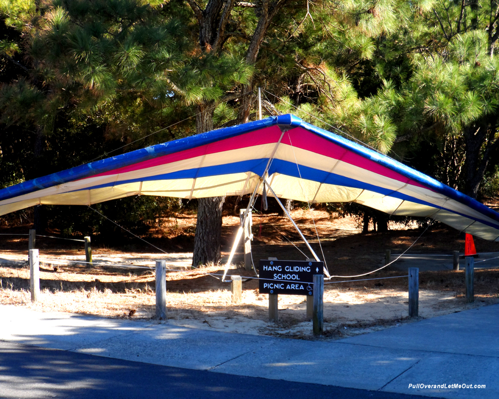 Hang glider resting on the ground outside the Jockey's Ridge State Park visitor center
