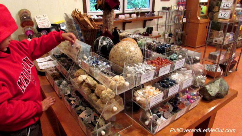 Boy in a gift shop looking at rocks and crystals at Linville Caverns Linville, NC