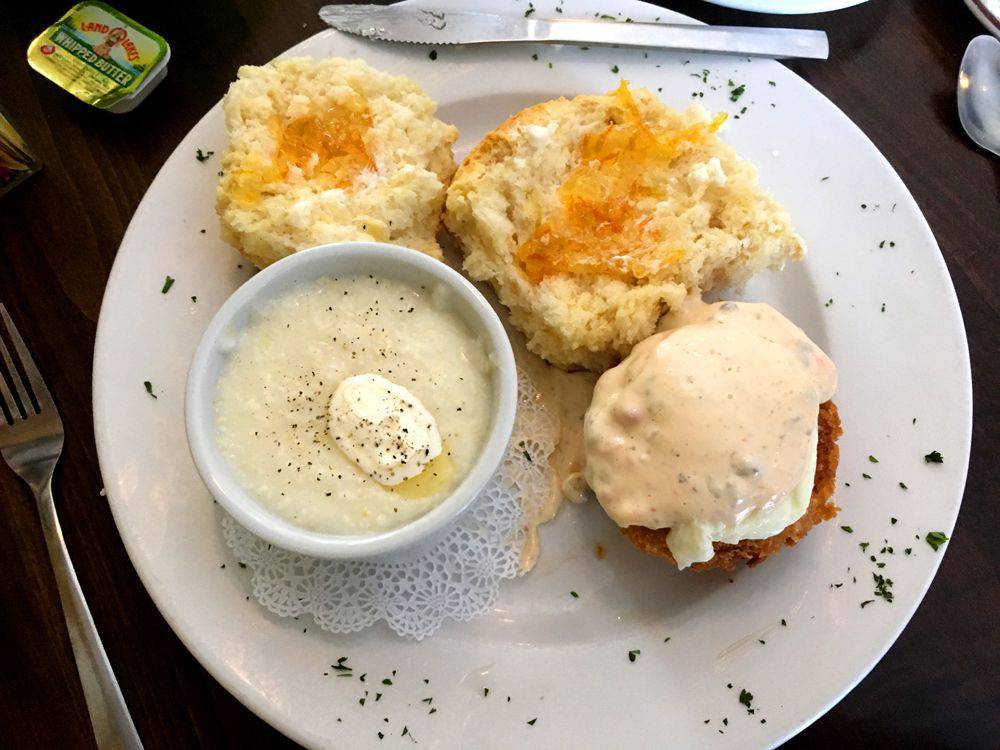 Eggs biscuit and grits on a breakfast plate