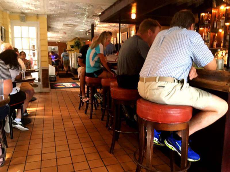 People sitting at the bar eating breakfast