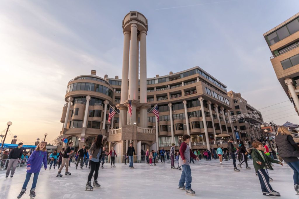 people skating on a rink in the city