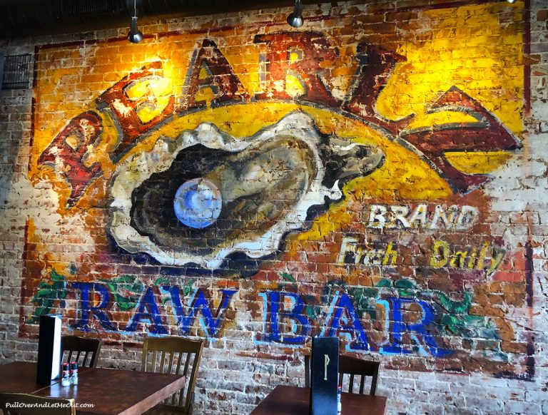 Pearlz restaurant art on exposed brick wall. PullOverAndLetMeOut