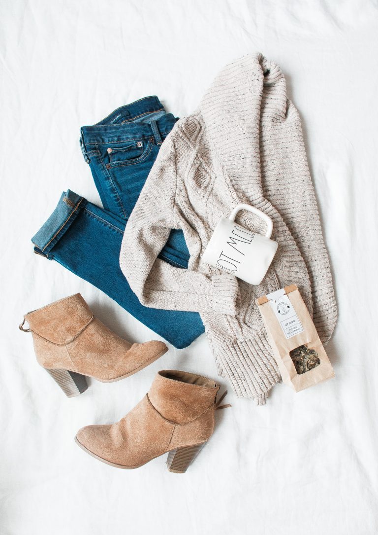 A picture of a pair of jeans, sweater, and demi boots.