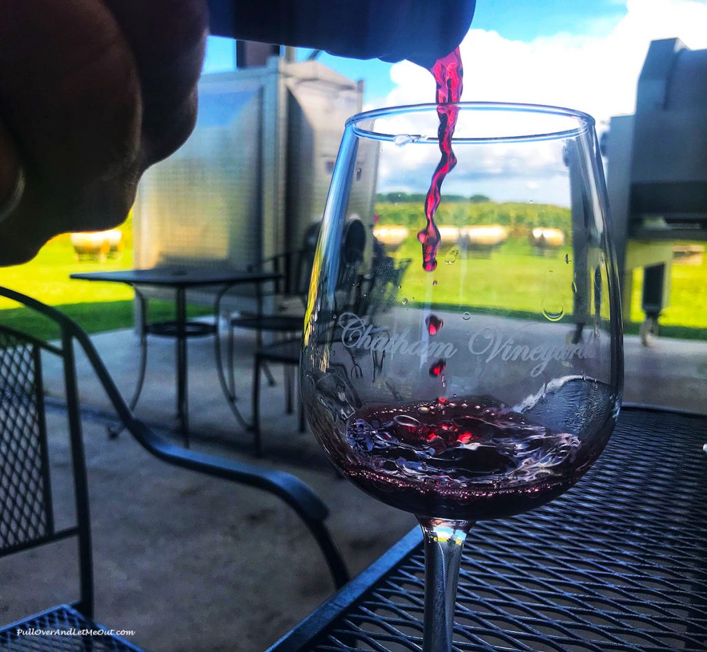 Wine pouring into a glass at Chatham Vineyards.