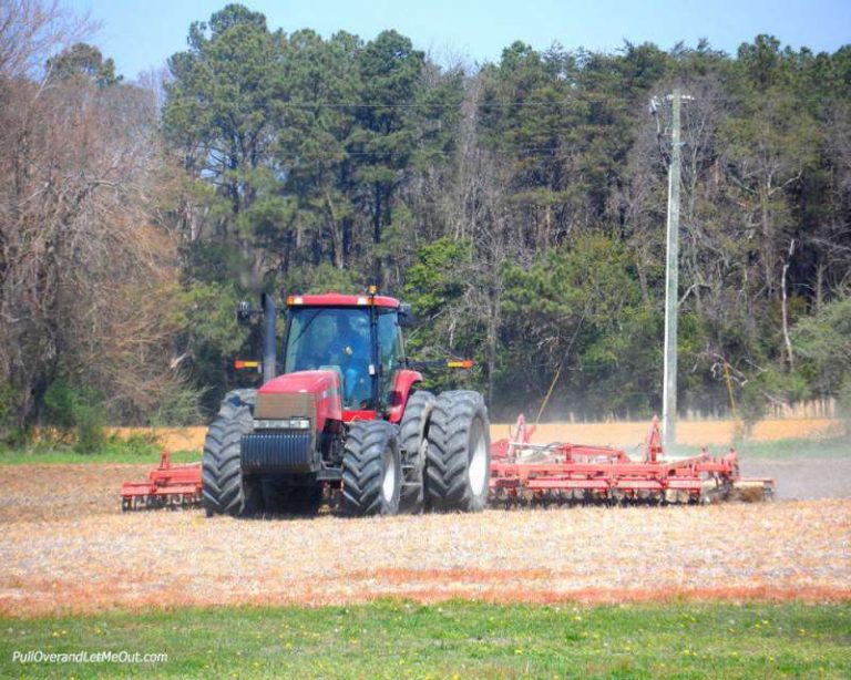 A r ed tractor tills the soil at Chatham Vineyards. PullOverAndLetMeOut