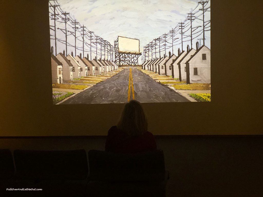 Woman sitting in front of a video screen