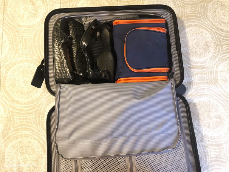 Shoes and toiletry bag in carry-on suitcase