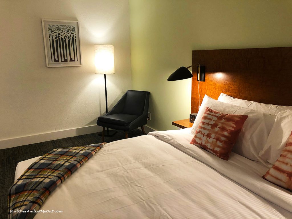 Bed and chair in a room at The Longleaf Hotel in Raleigh PullOverAndLetMeOut