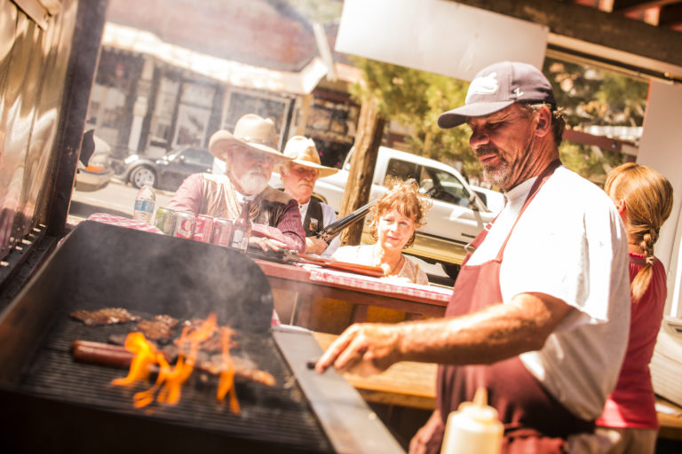 Man cooking BBQ on a fire in Virginia City, Nevada