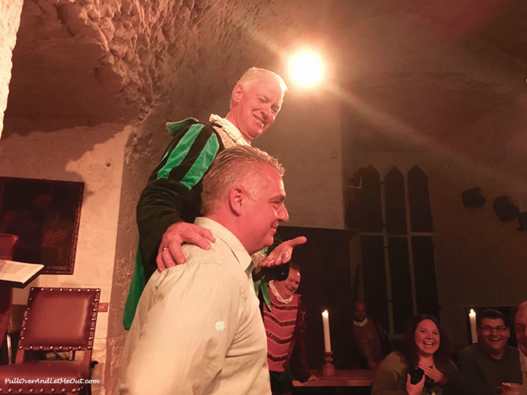 Two men onstage at a medieval banquet