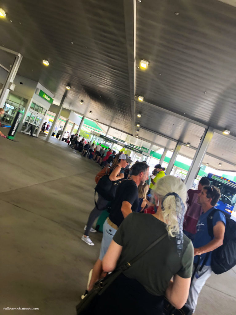 a long line at a rental car pickup location