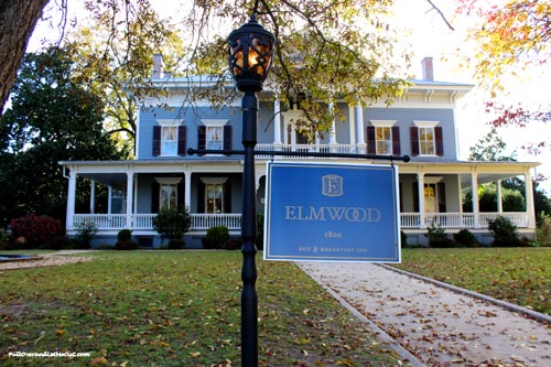 A sign in front of a historic home