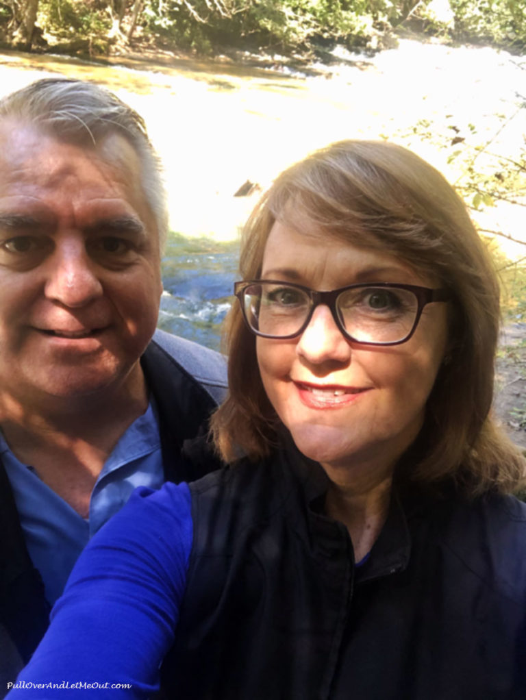 man and woman at a waterfall