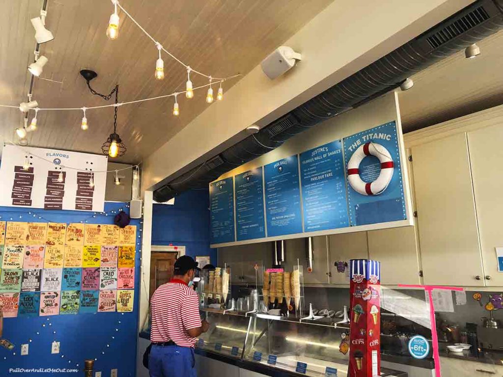 person ordering ice cream in an ice cream shop