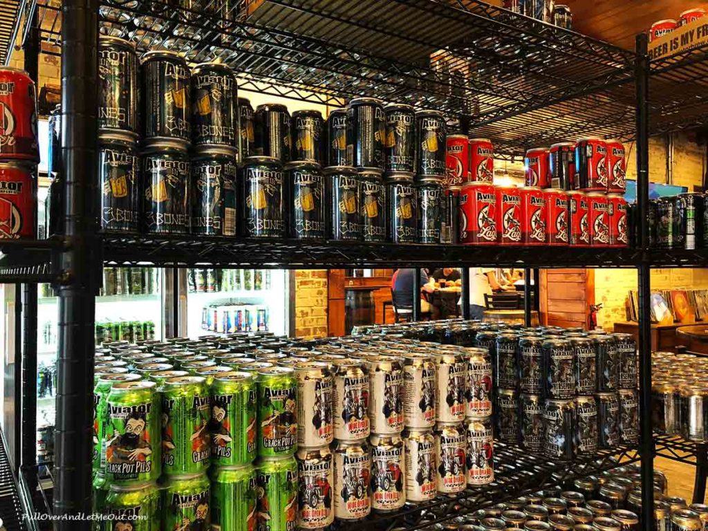 stacks of beer cans to purchase at Aviator Brewing Co. in Fuquay-Varina, NC PullOverAndLetMeOut