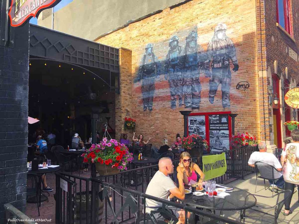 people dining outside a brick building