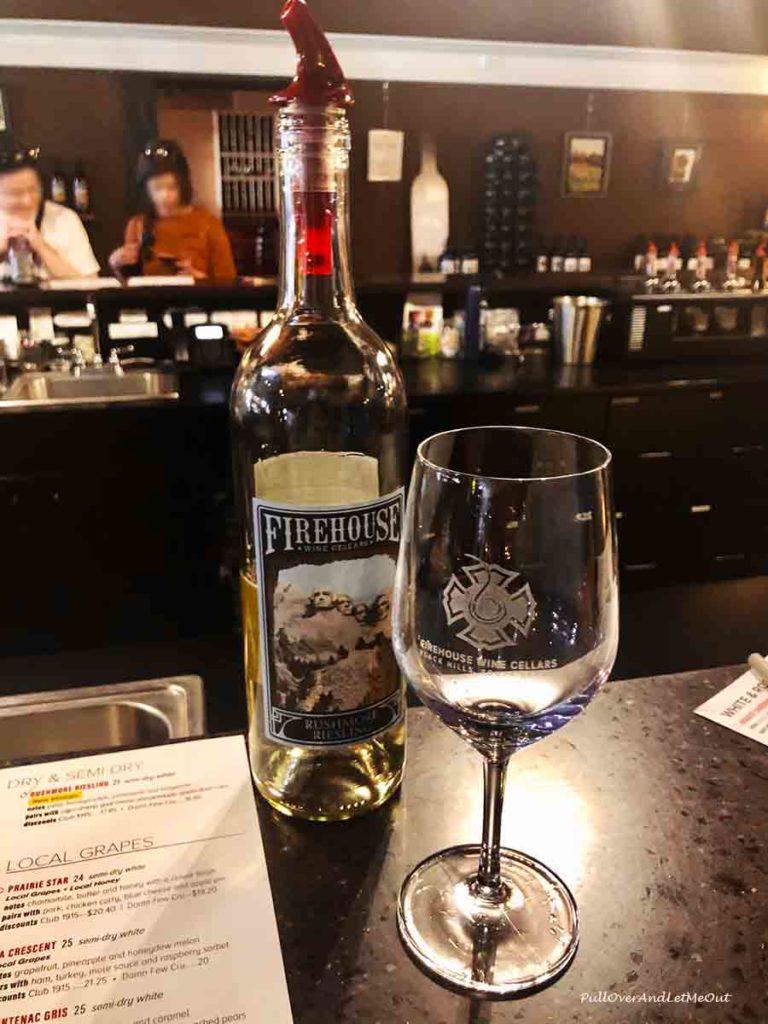 Bottle of wine and a glass at Firehouse Wine Cellars