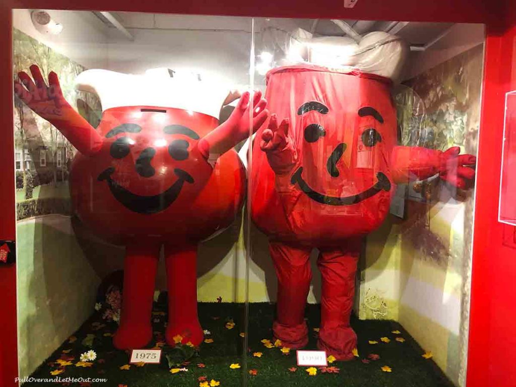 Two Kool-Aid Man costumes inside a display case in a museum