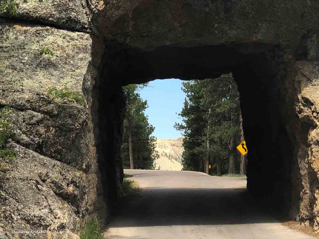 Mount Rushmore seen through a narrow tunnel in the mountains