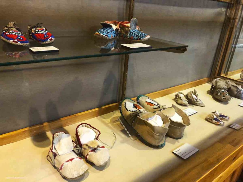 Indian moccosans on display in a glass case