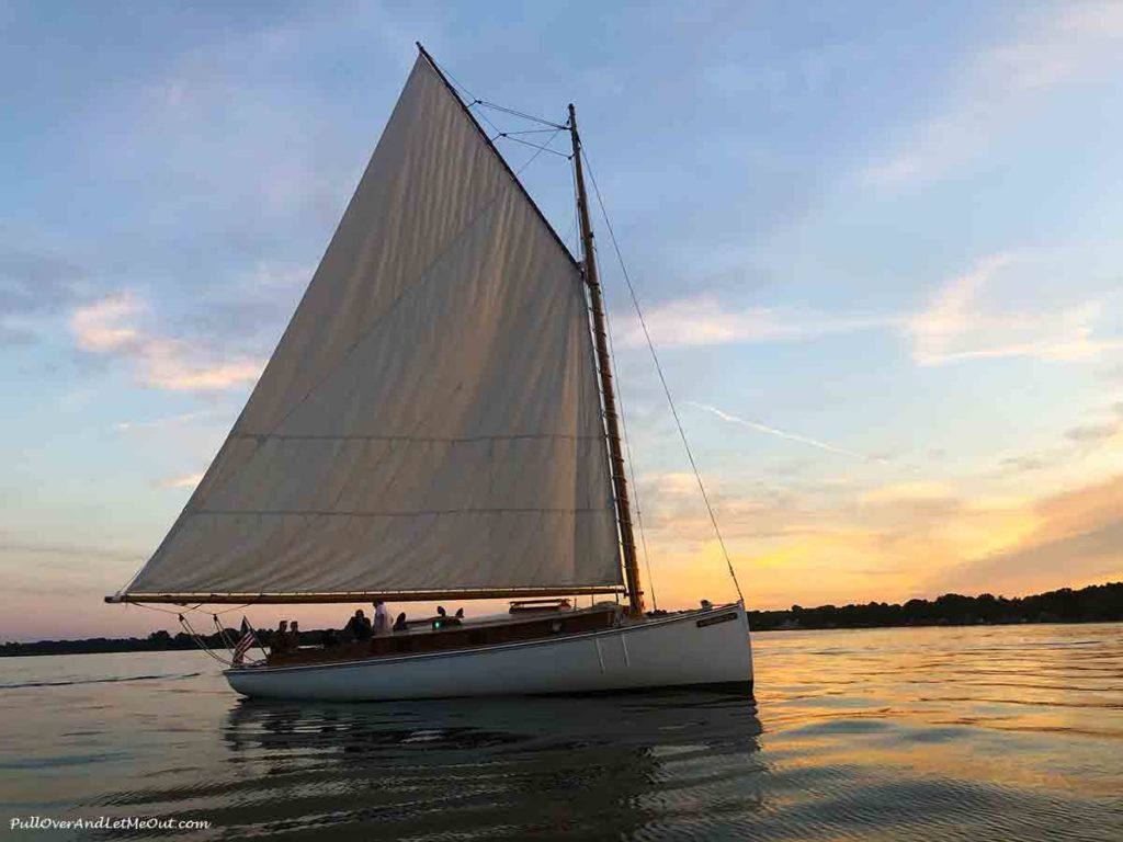 a sailboat on the water at sunset