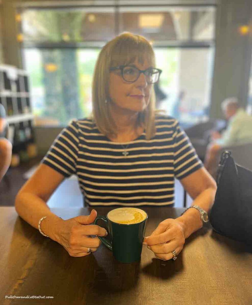 a woman drinking a coffee