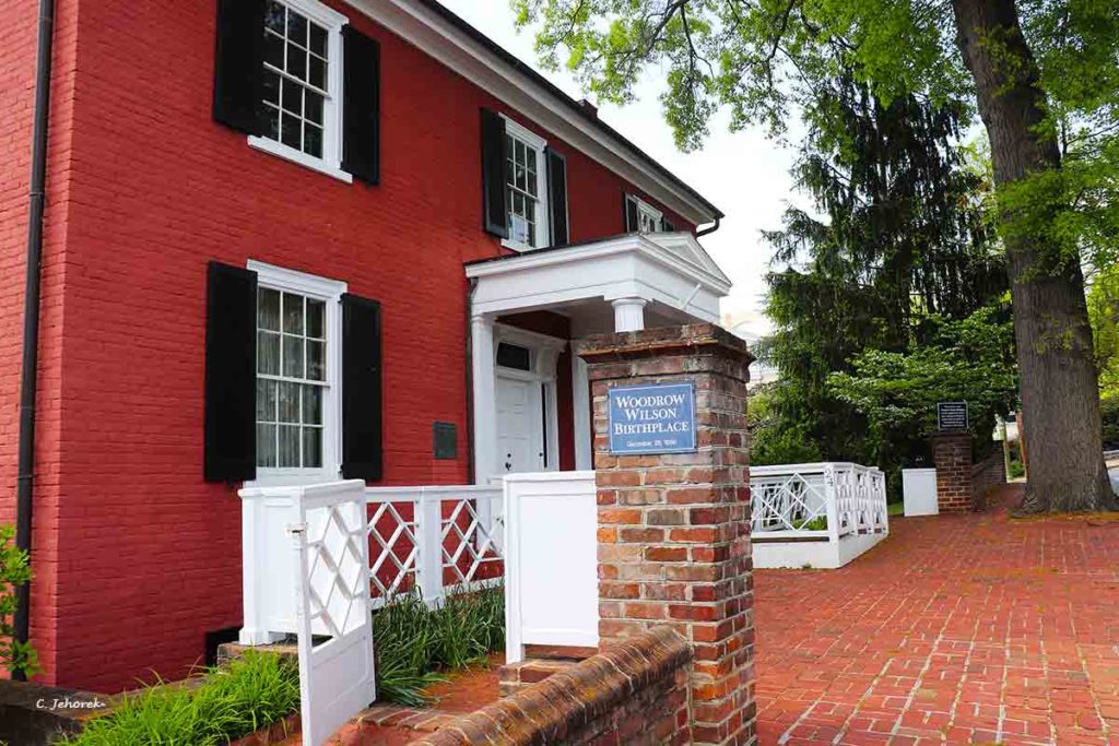 a red brick house with black shutters
