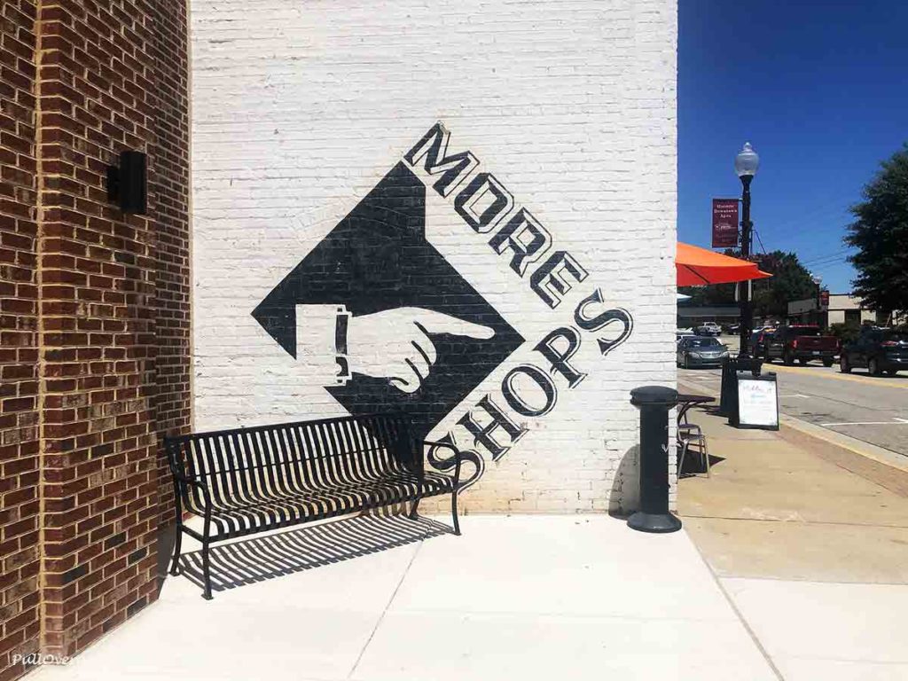 a mural that says more shops