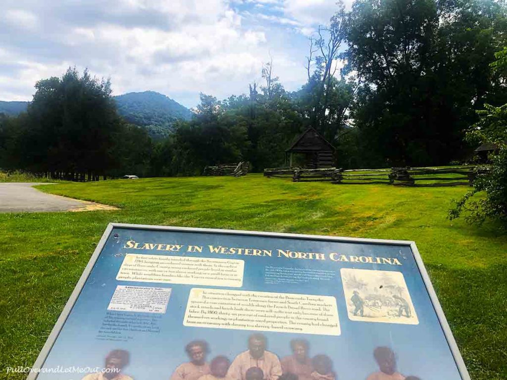 a plaquard in front of a mountain