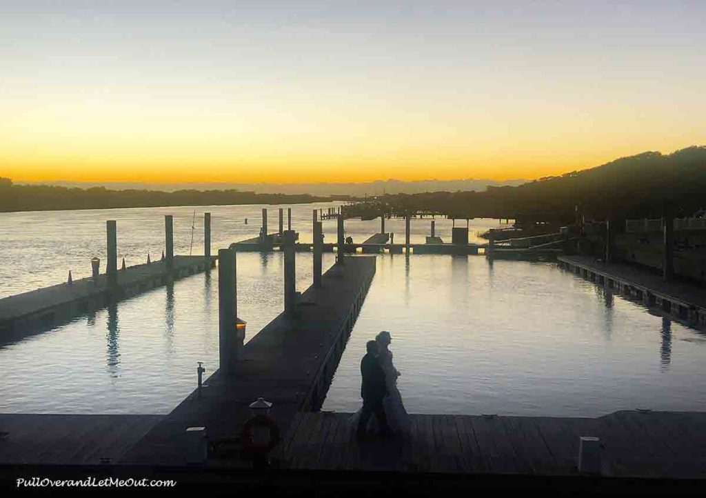 a bride and groom at sunset