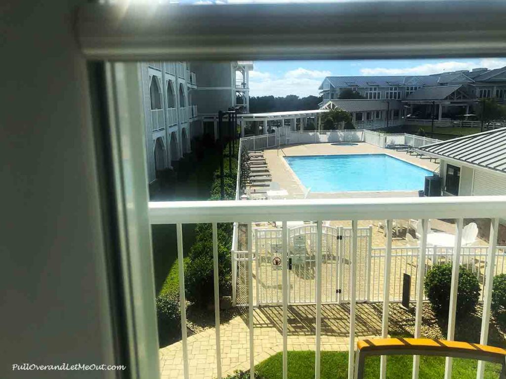 a balcony overlooking a swimming pool