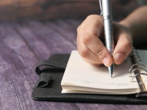 a person writing a list