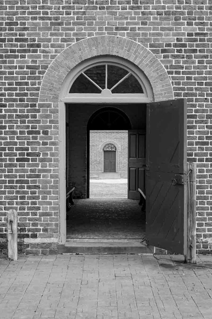 black and white photograph of historic horse stables