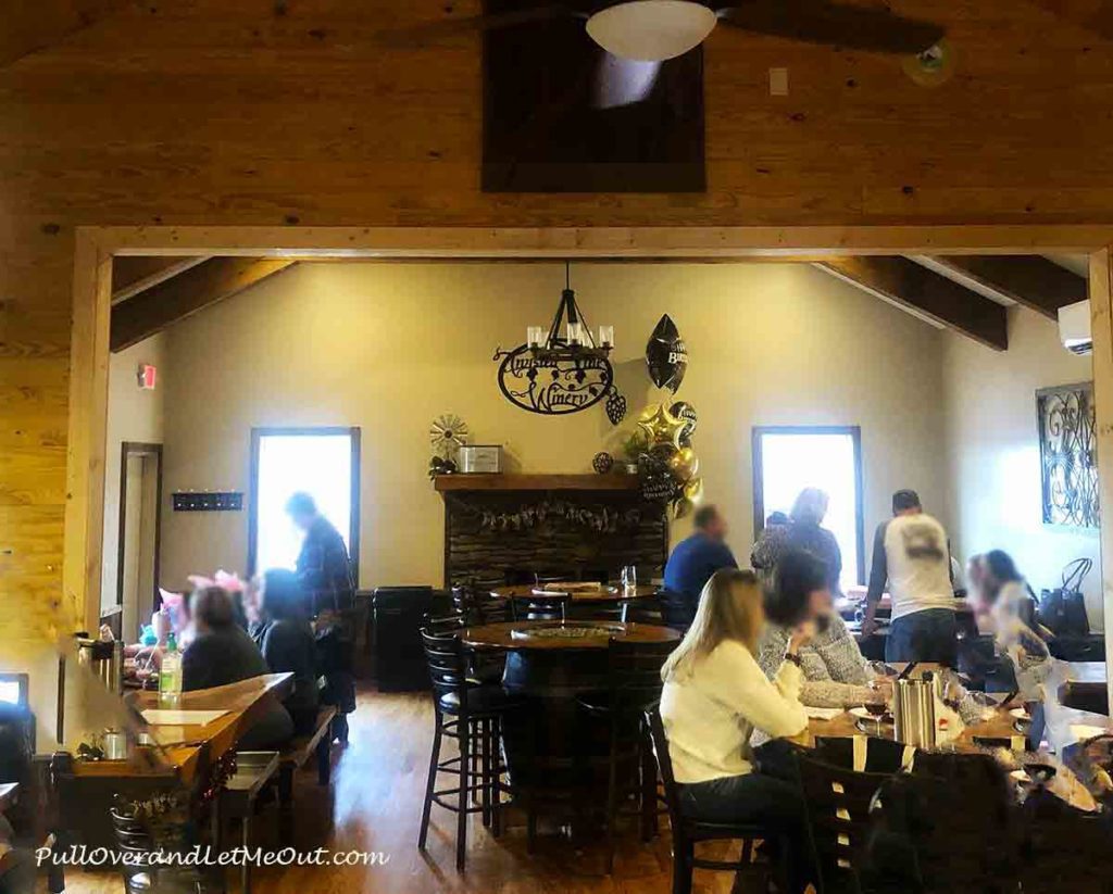 a wine tasting room with a fireplace in the back.