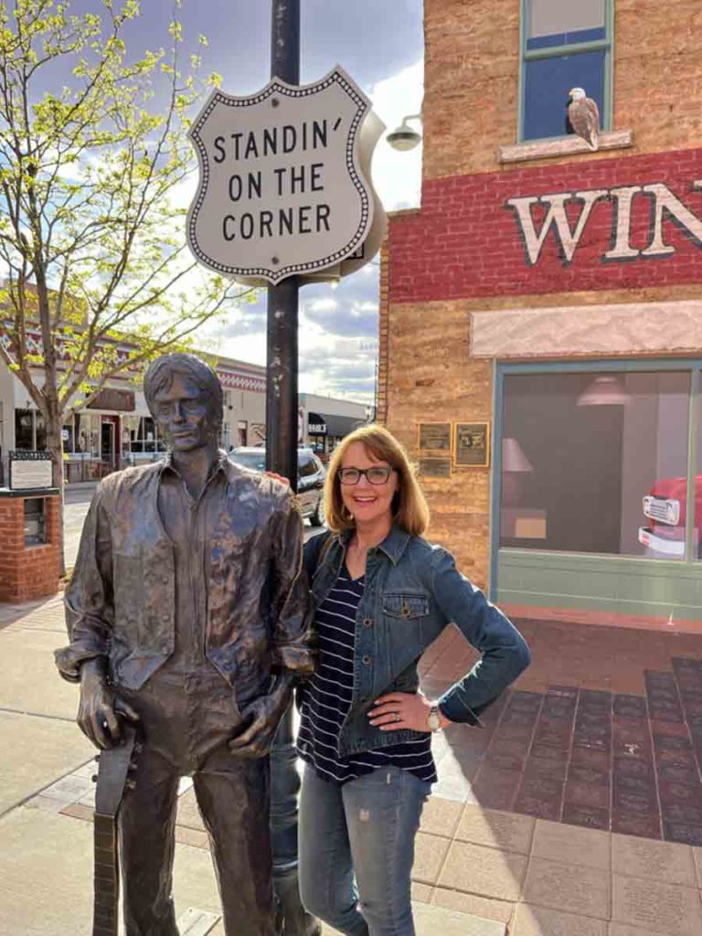 woman standing on a corner in Winslow AZ