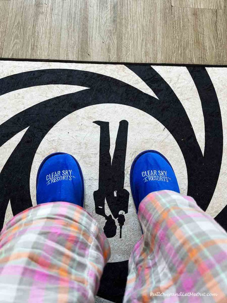 a pair of feet wearing blue slippers