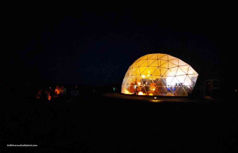 A dome with people inside at nighttime