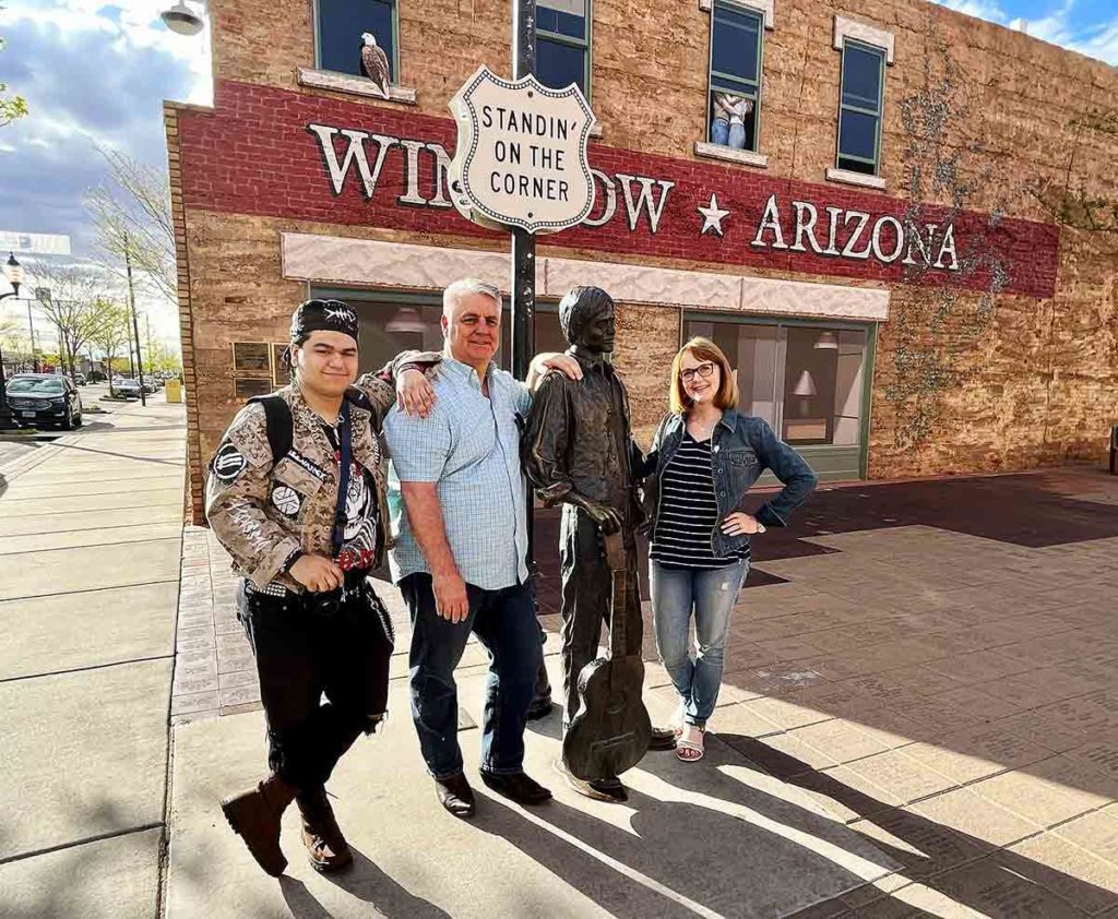 family standing on a corner in winslow arizona