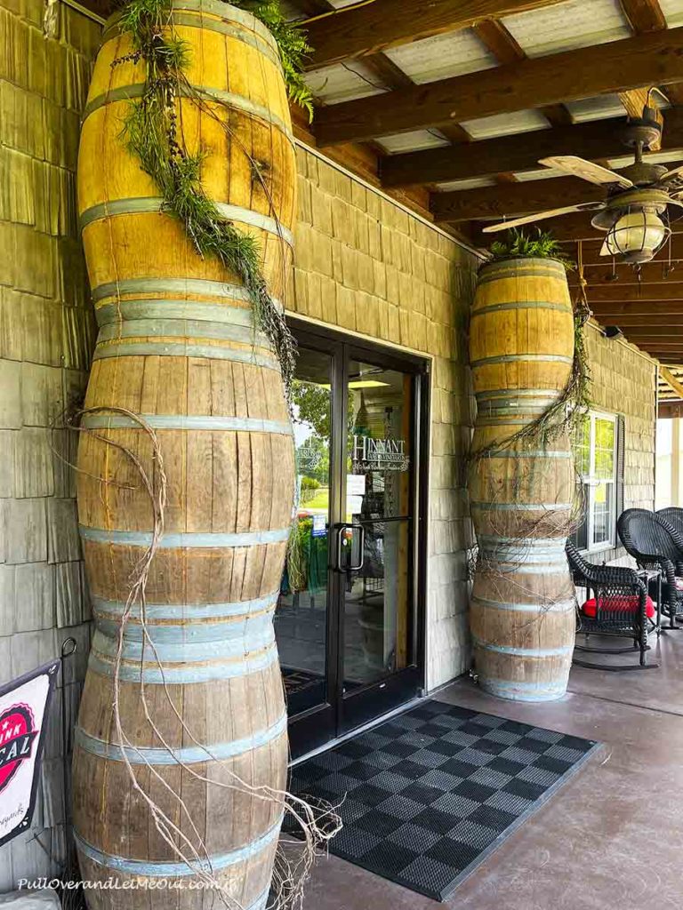 oak barrels beside a door to a winery