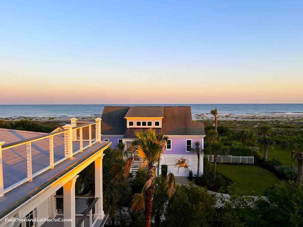 a sunset view from a balcony at the beach