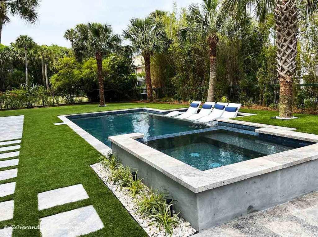 a swimming pool with palm trees around it