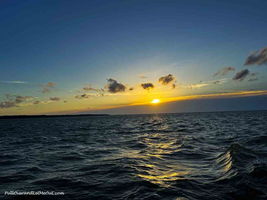 the sun setting on the horizon on the Roanoke Sound