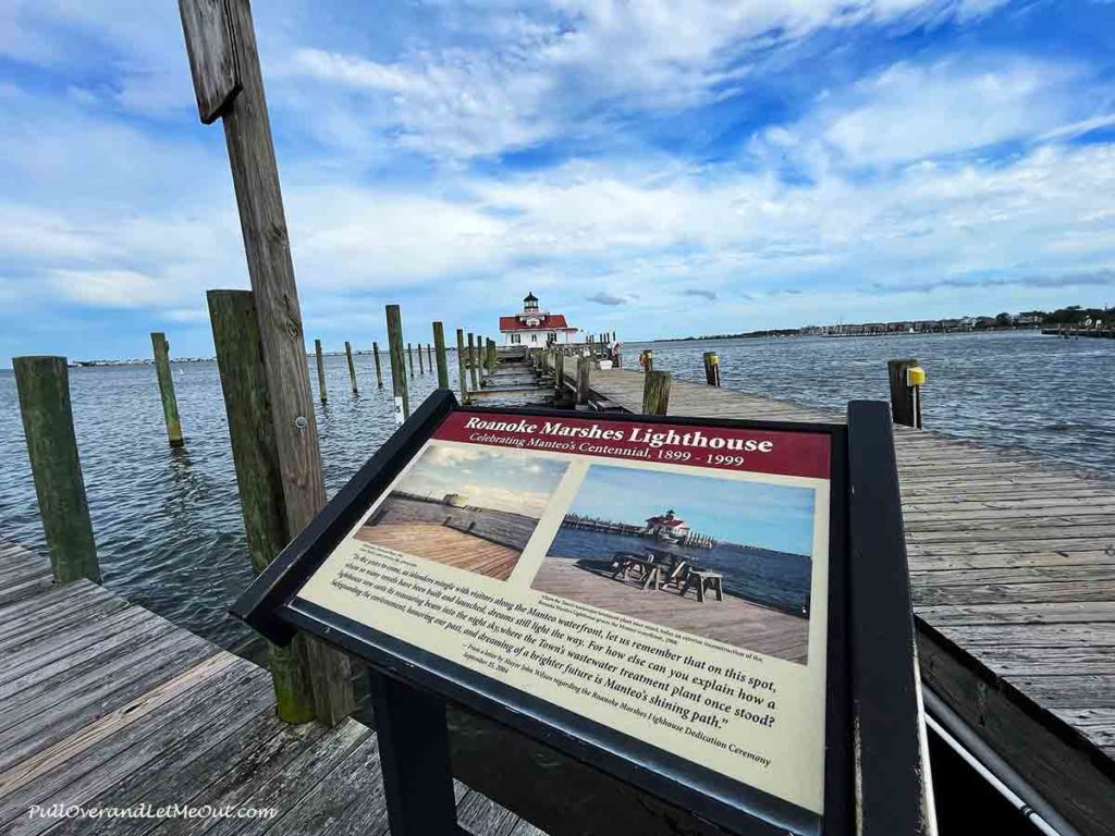 a historic marker in front of a lighthouse