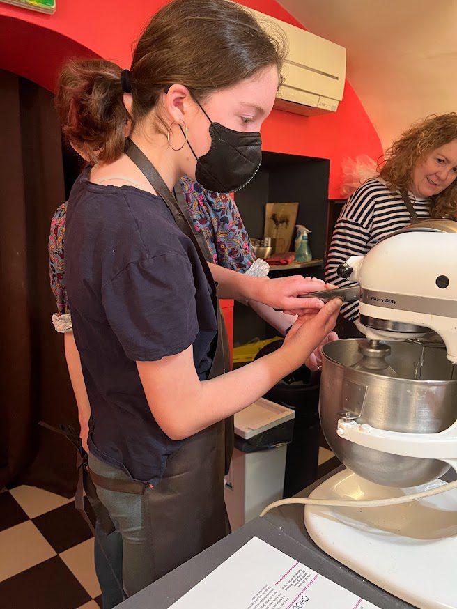 a woman pouring water into a blender