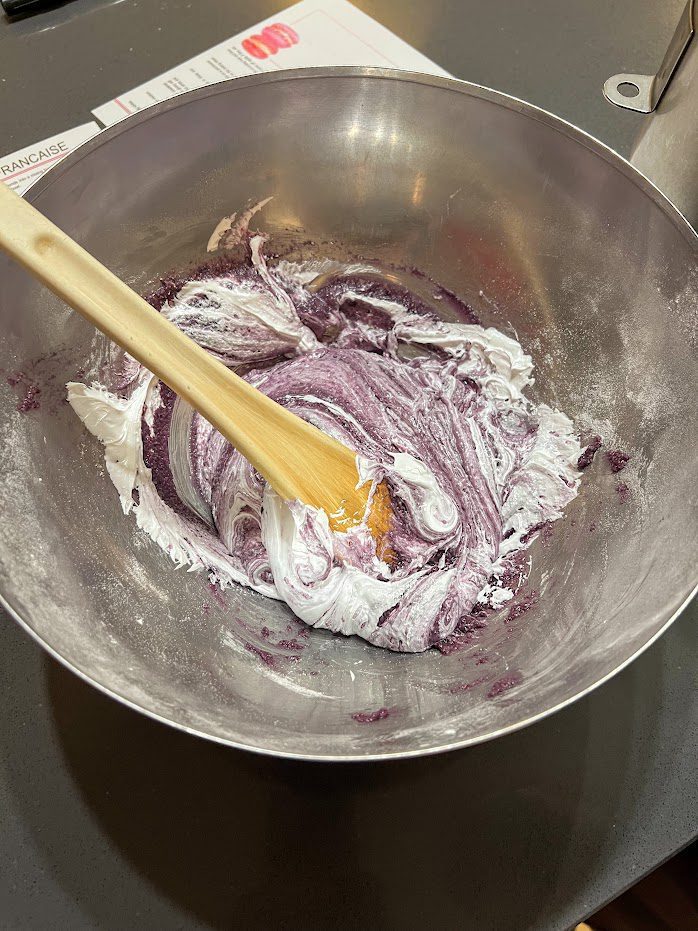 a mixing bowl with colorful batter