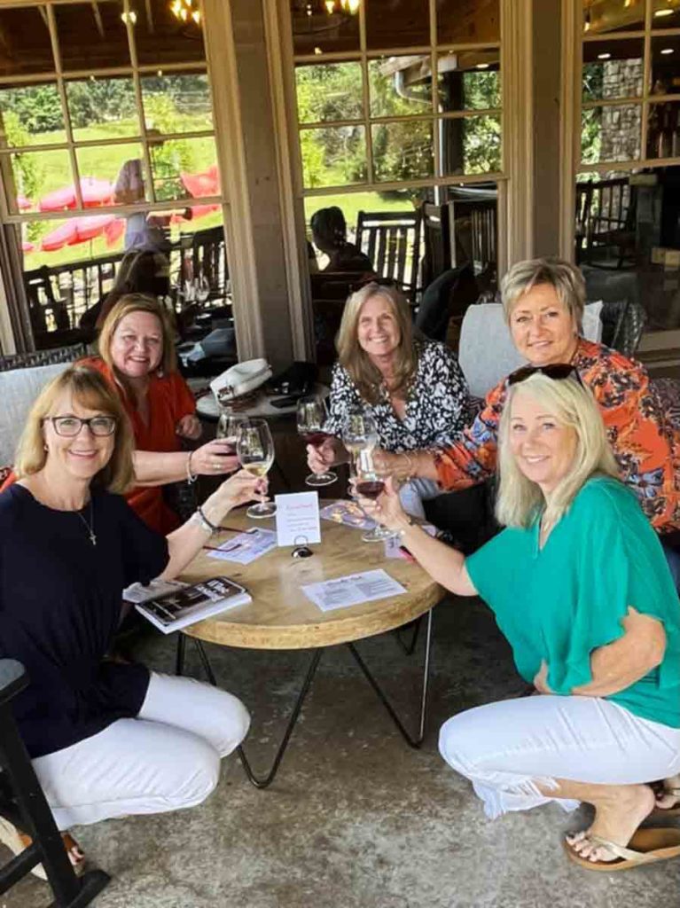 a group of women holding wine glasses